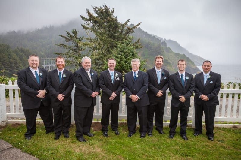 A group of men in suits and ties are posing for a picture.