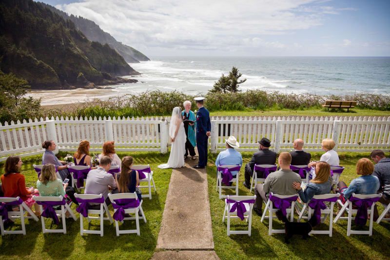 A bride and groom are getting married in front of a crowd of people.