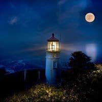 A lighthouse is lit up at night with a full moon in the background.