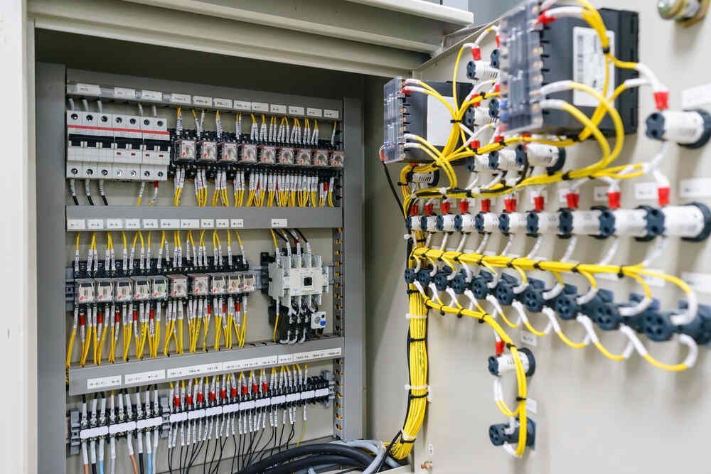 Electrical control panel with many wires and components.