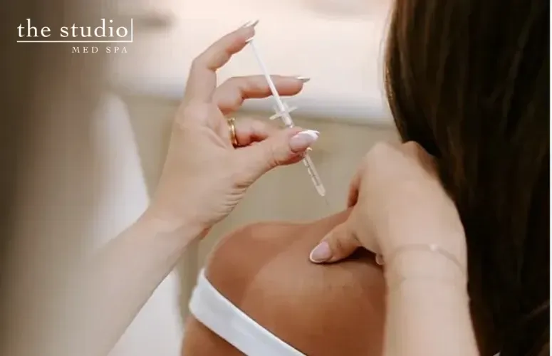 doctor injecting barbie botox to patients trapezius muscle in san marcos