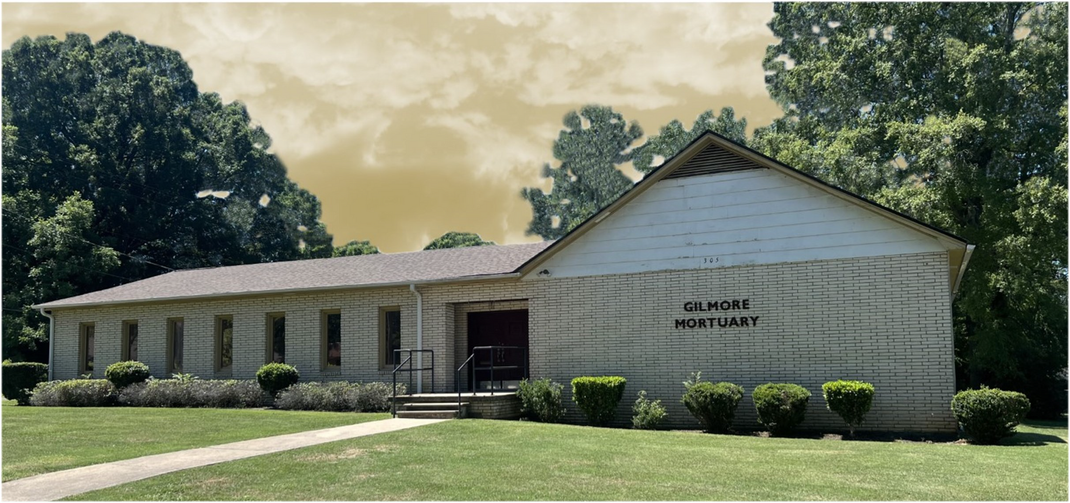 White building with a brown roof and a sign that reads, 