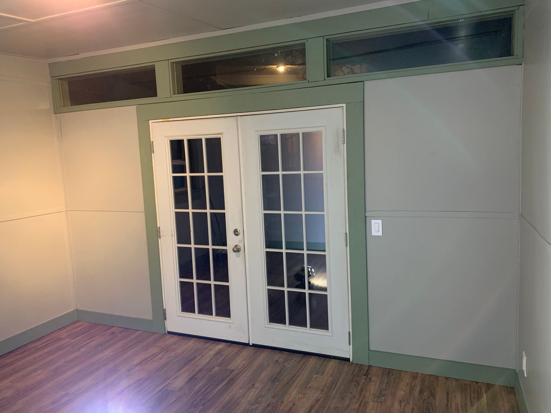 A room with a wooden wall and a wooden floor.