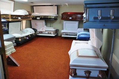 Dorm room with bunk beds and single beds around a red carpeted floor