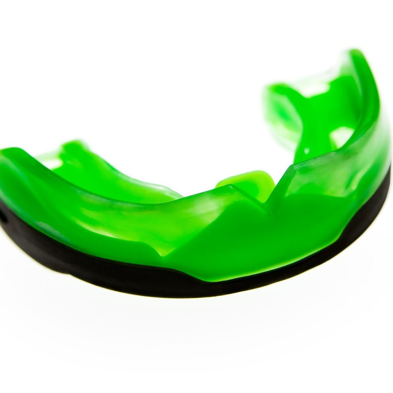 Green and black mouthguard on white background.