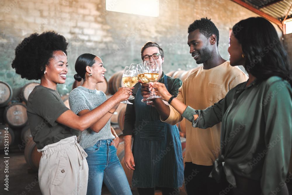 Group of coworkers raising drinks in a toast at a casual indoor gathering