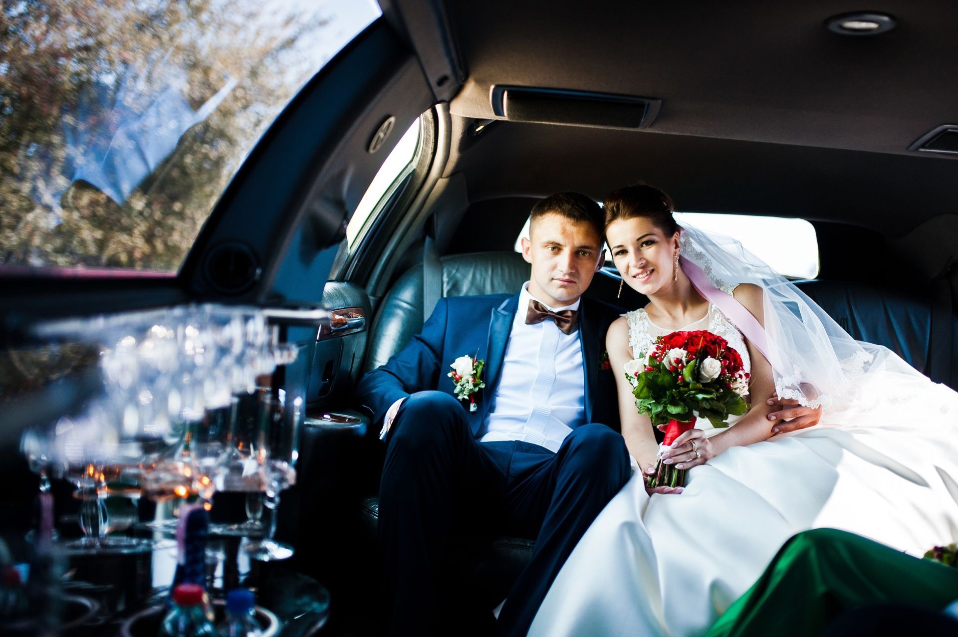 Wedding couple indoor the limousine.