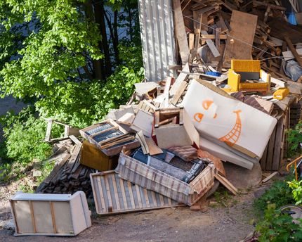 A pile of junk with a smiley face painted on it