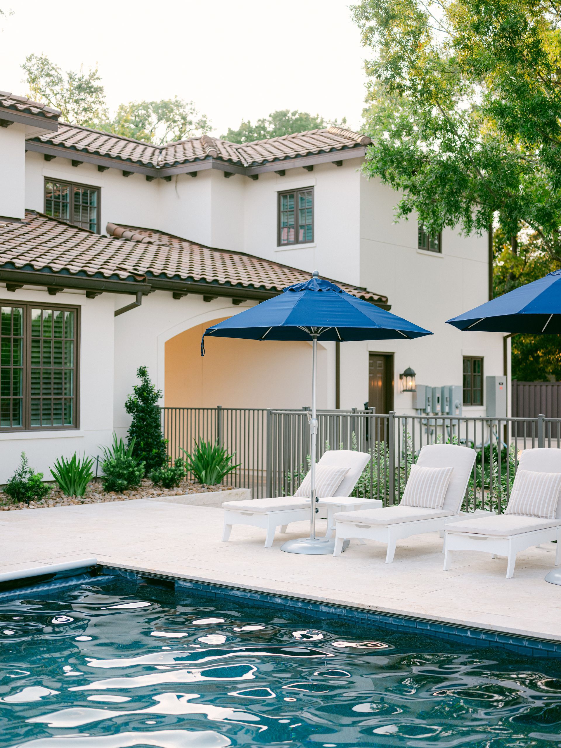 A large white house with a swimming pool in front of it