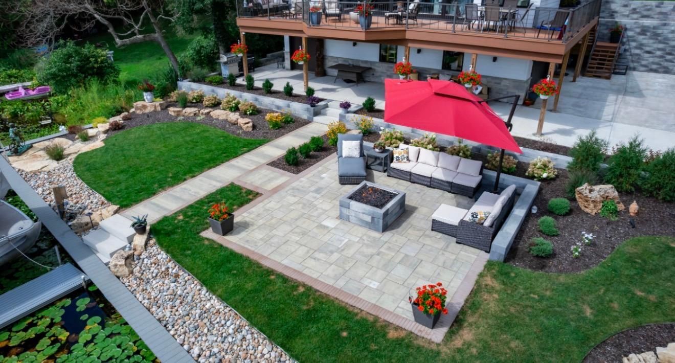 A patio with a fire pit in the middle of it.
