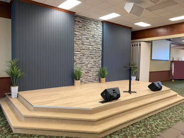 Contemporary church building with prominent wooden cross and A-frame design.