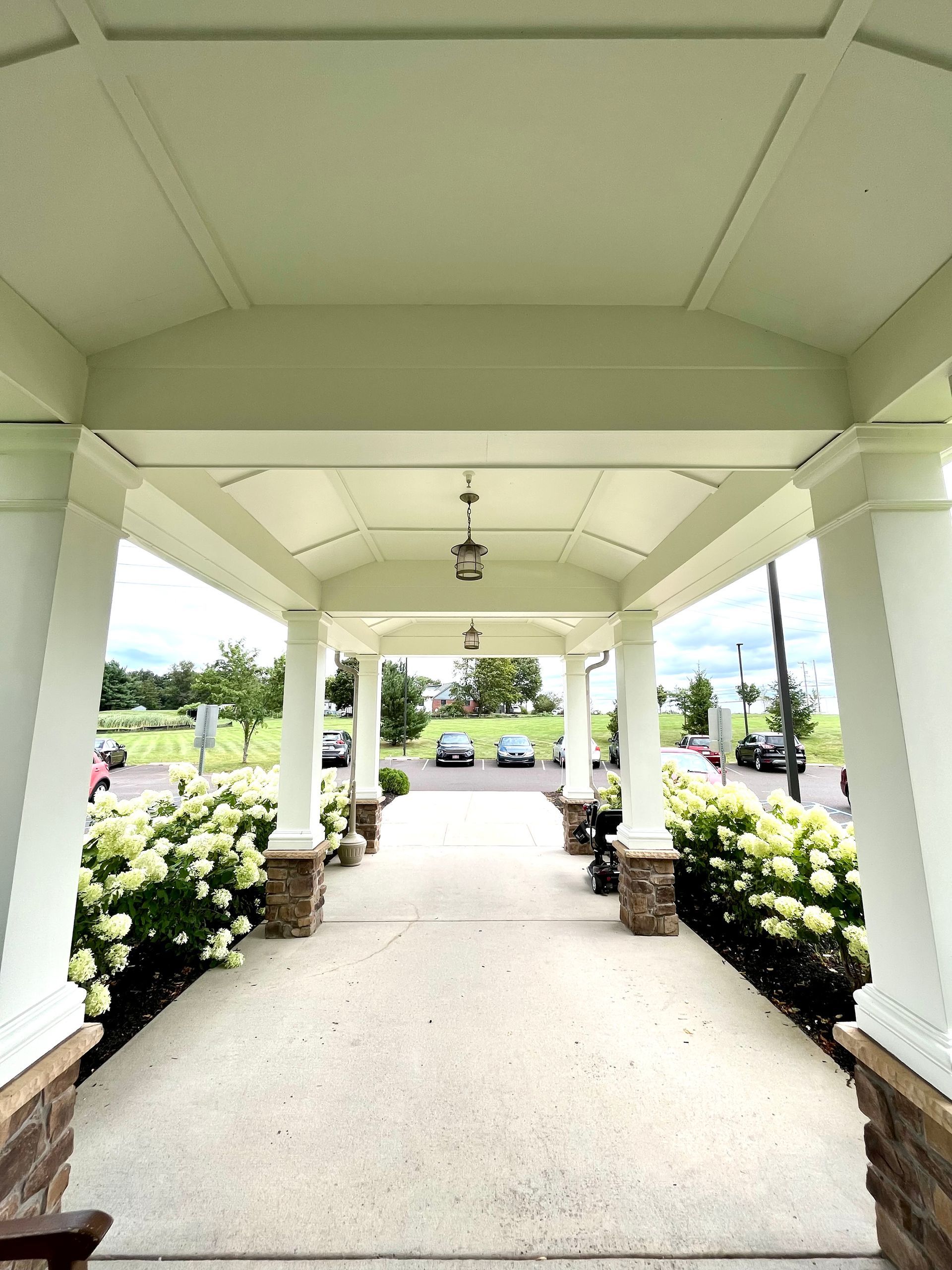 A covered walkway leading to a parking lot