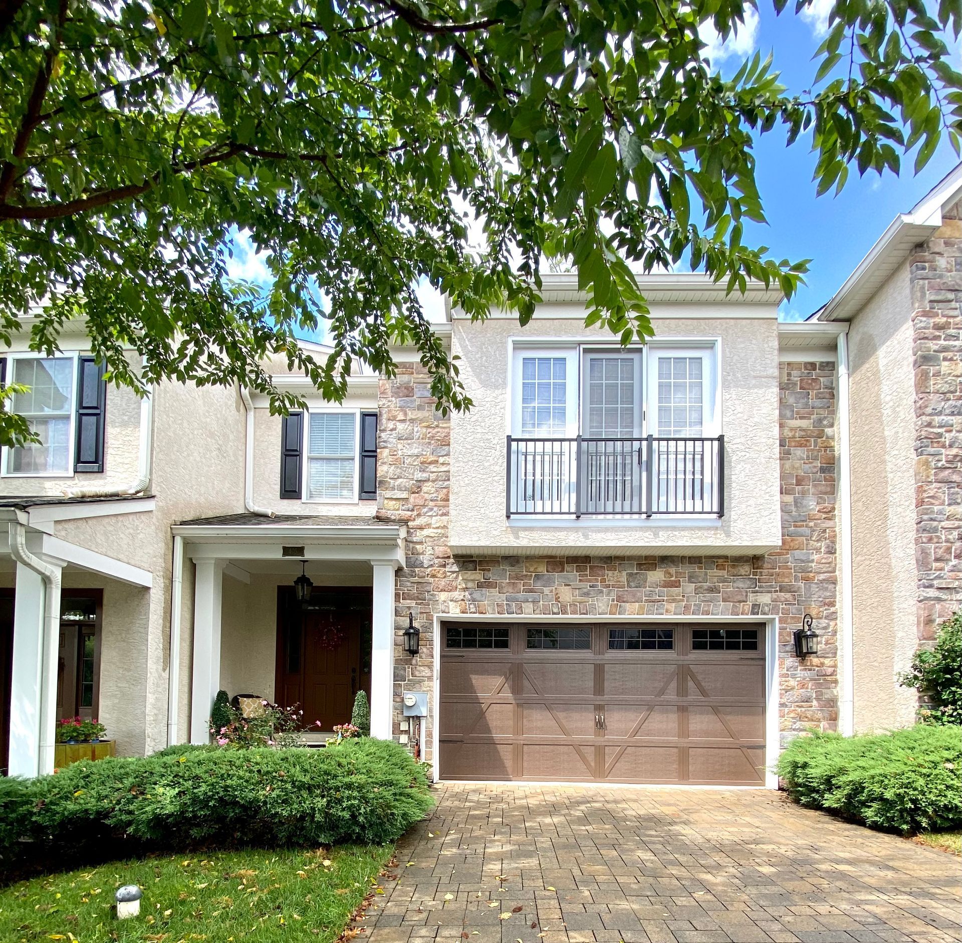 The front of a house with a brown garage door