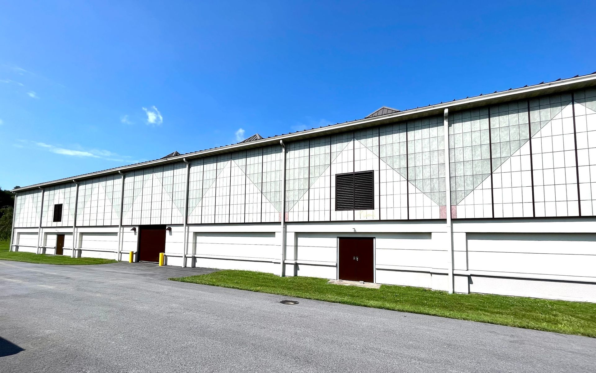 A large white building with a blue sky in the background.