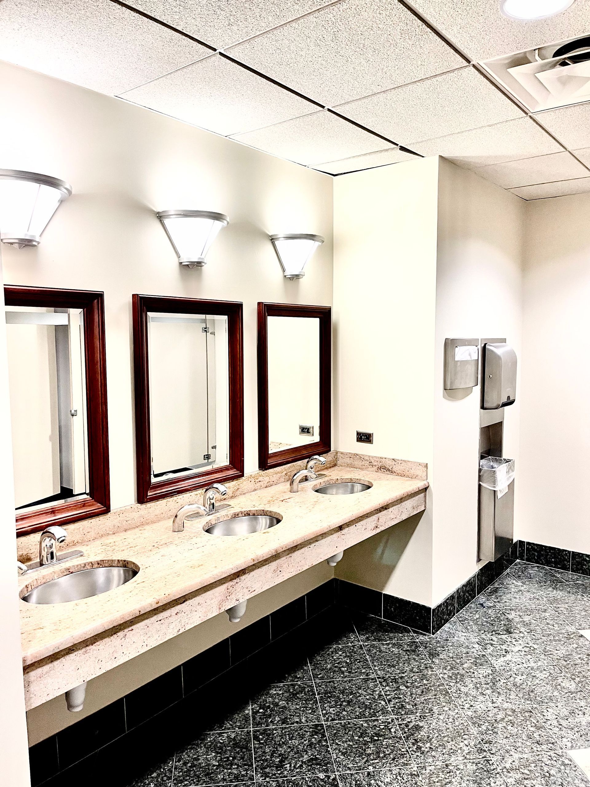 A bathroom with a lot of sinks and mirrors