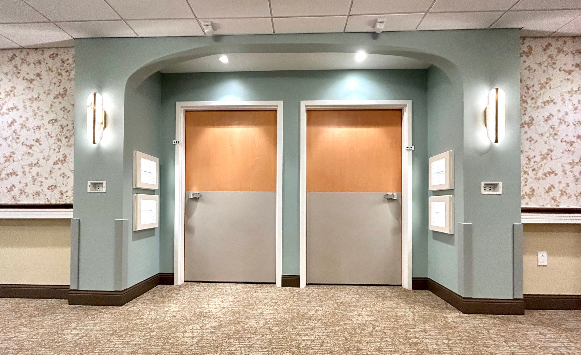 A hallway with two doors and a carpeted floor