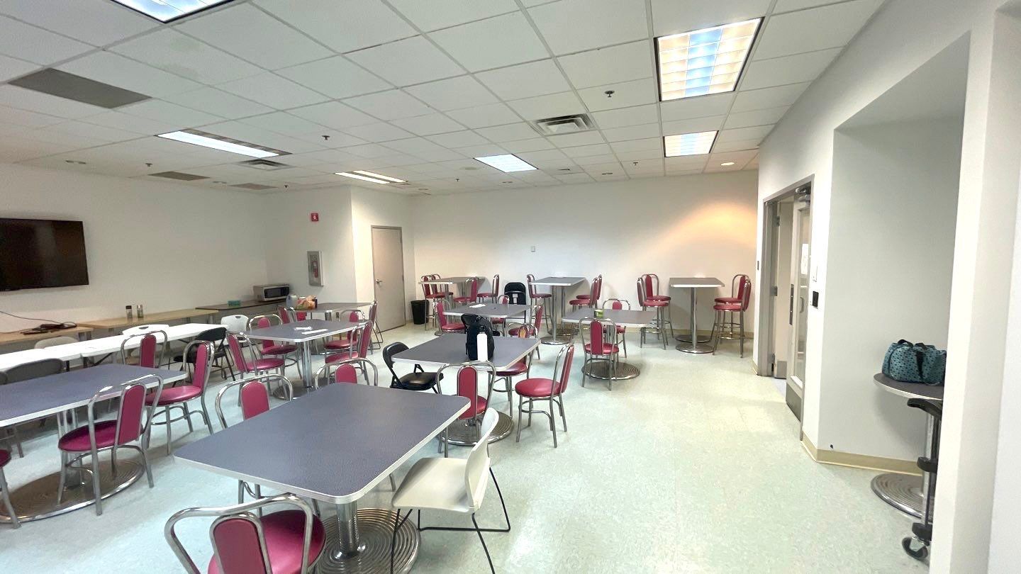 A large room with tables and chairs in it