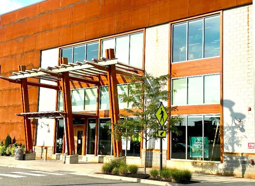 A large building with a lot of windows and a wooden entrance.