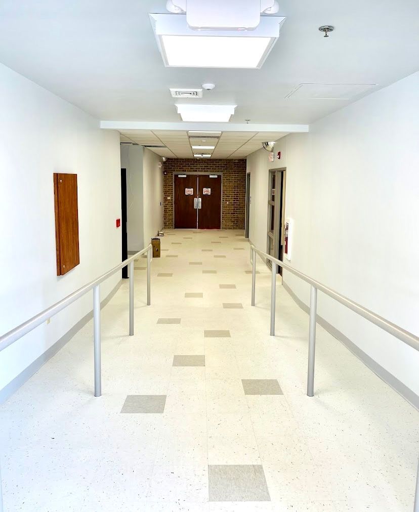 A long hallway with a fire extinguisher on the wall