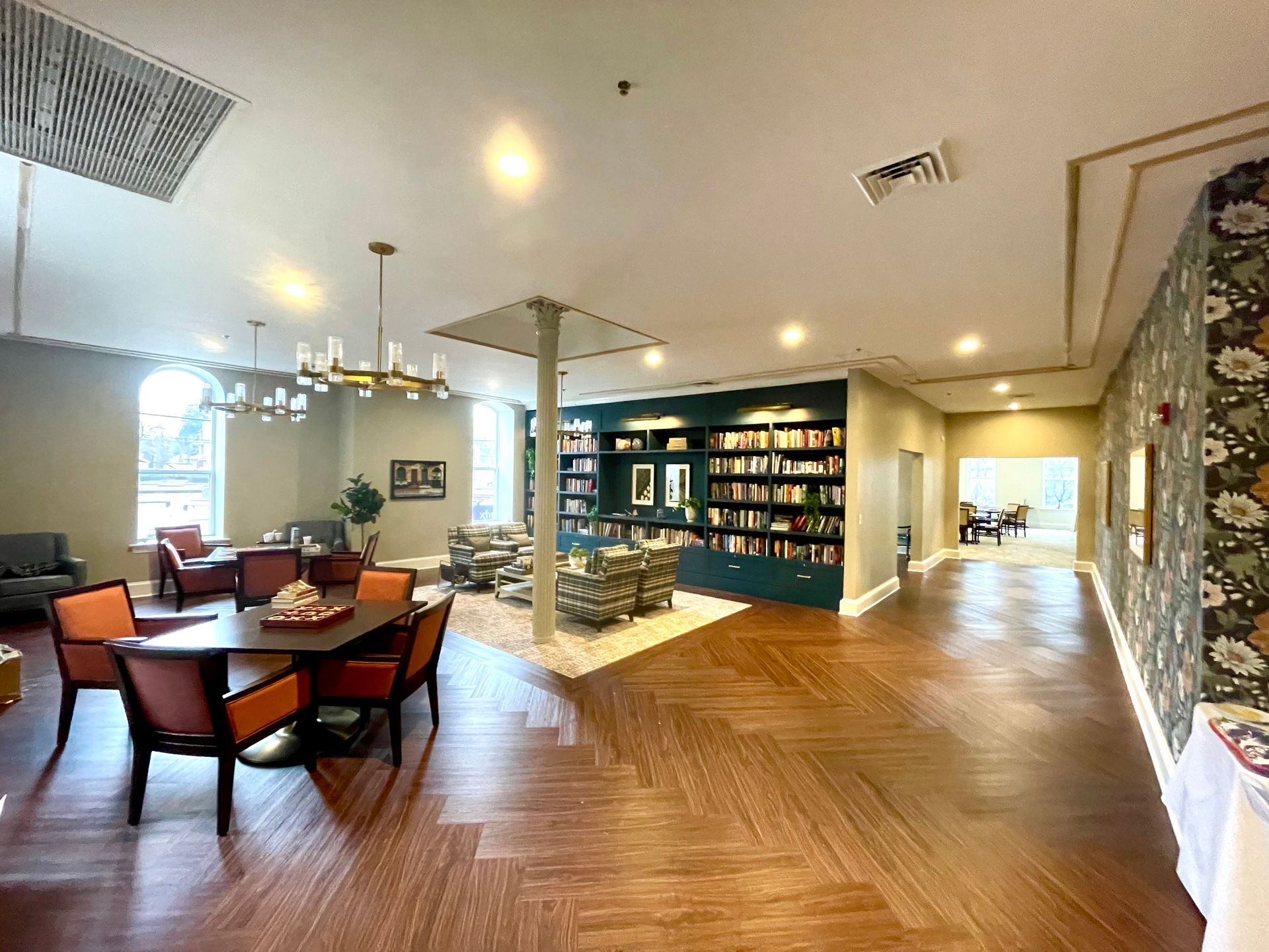 A large room with a table and chairs in it.
