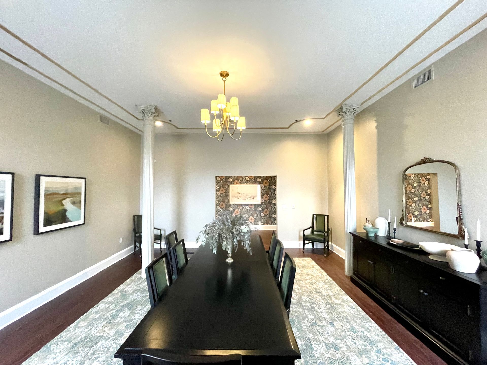 A large dining room with a long table and chairs