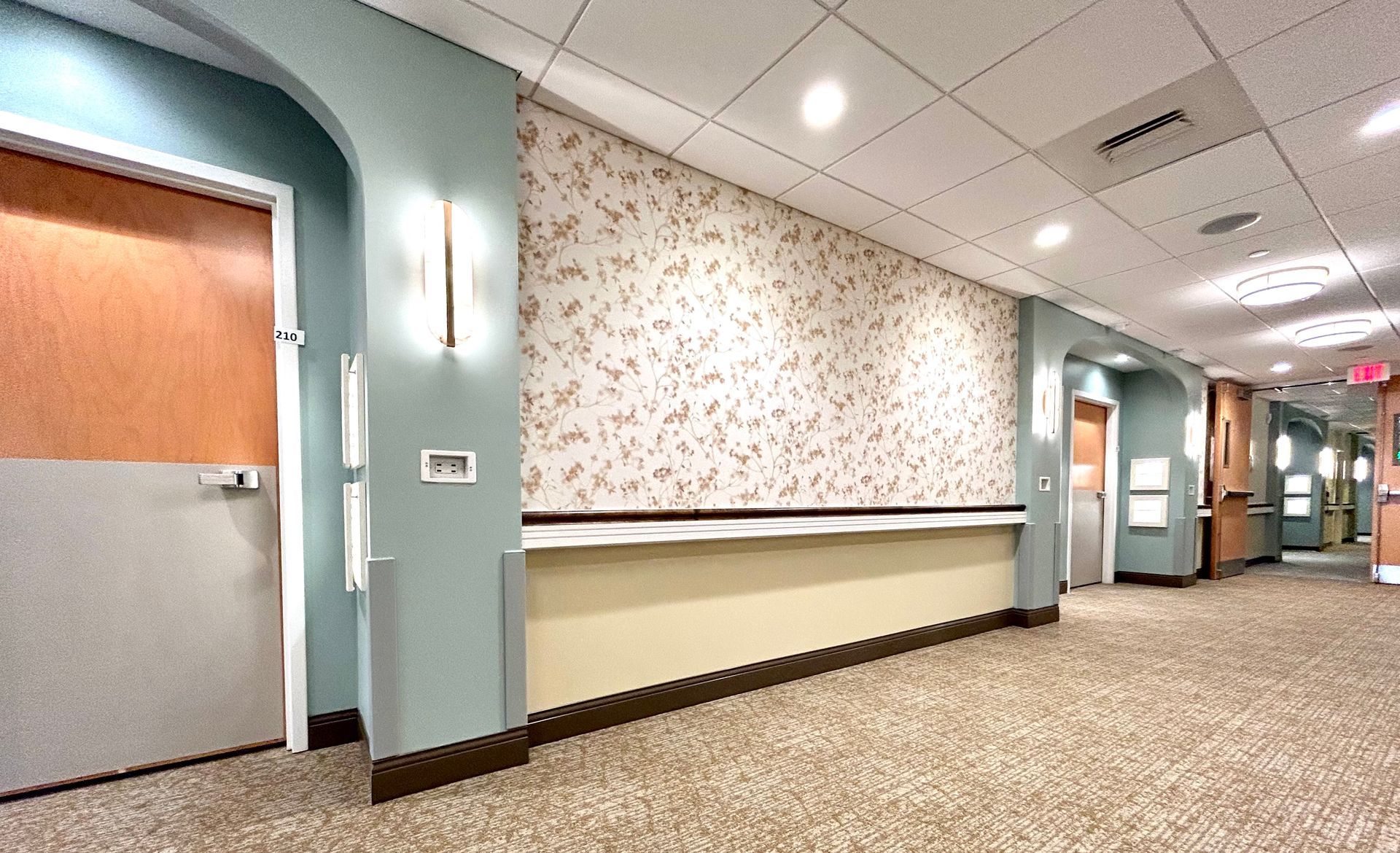 A long hallway in a hospital with a reception desk