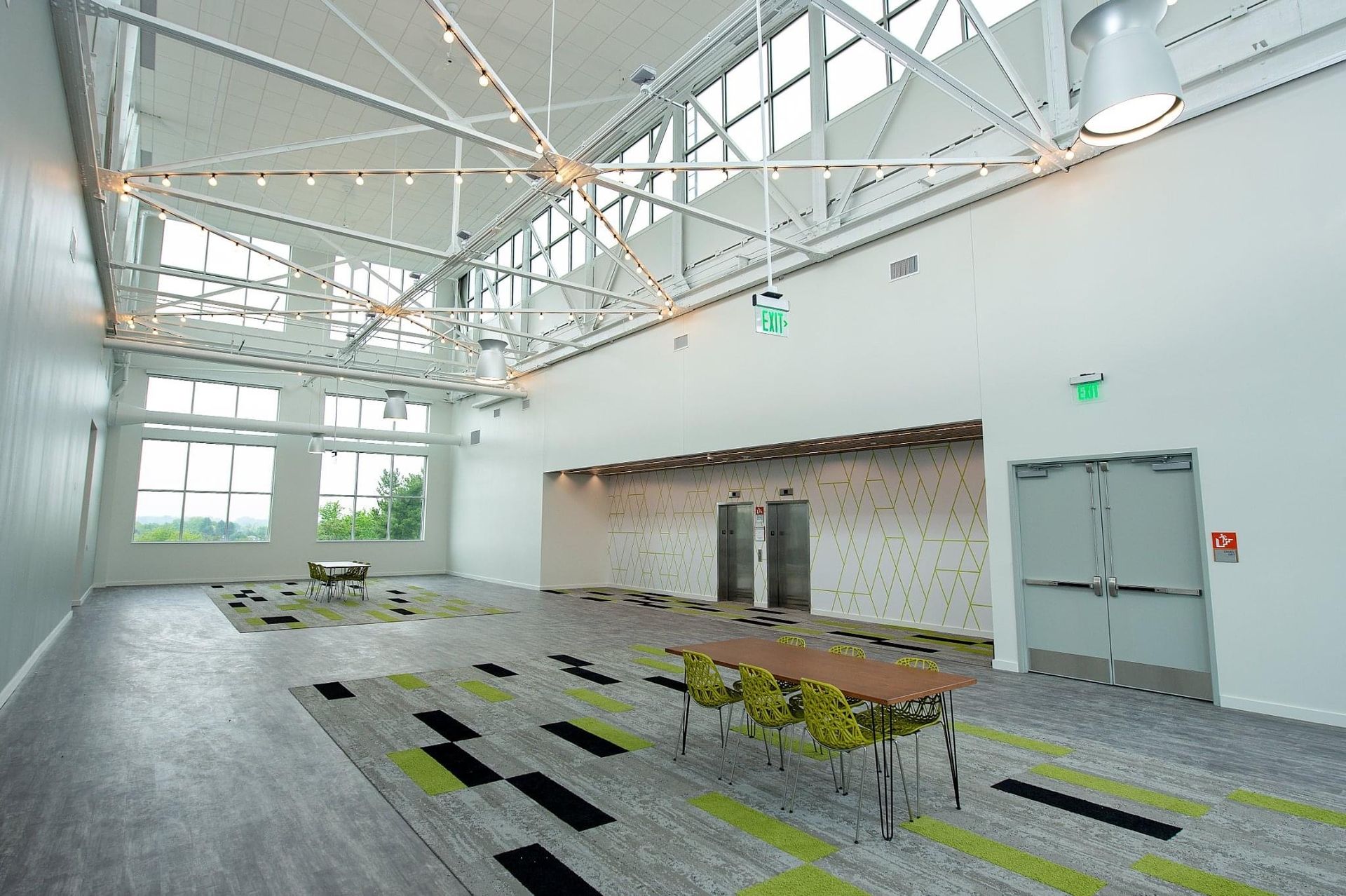 A large empty room with a table and chairs in it