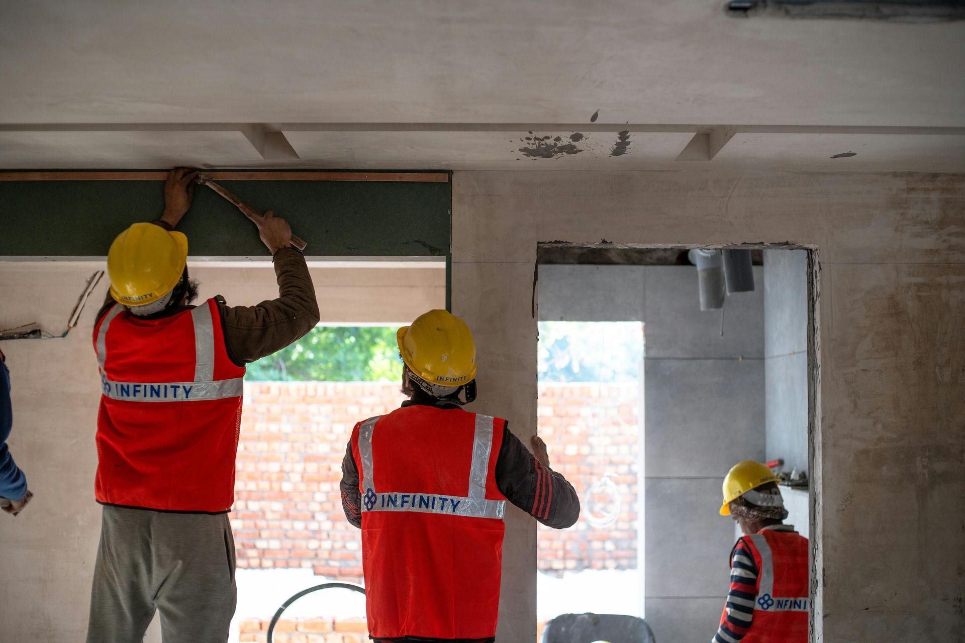 General contractor consulting with business clients about office renovation project planning and coordination