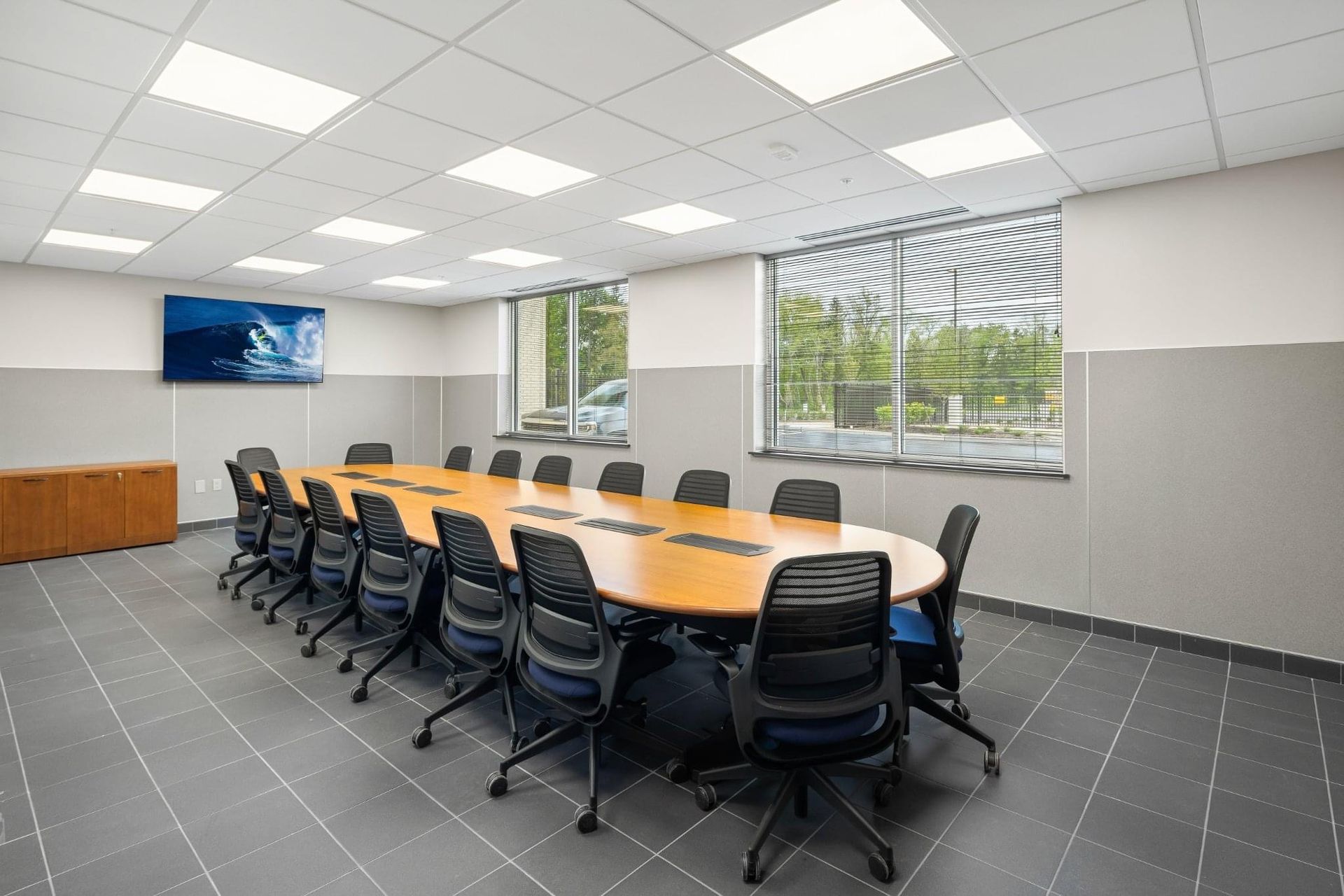 A conference room with a long table and chairs.