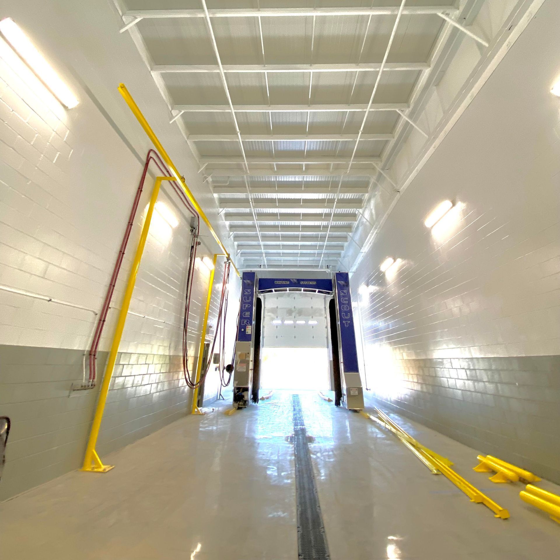 A very long hallway with a machine that says ' car wash ' on it