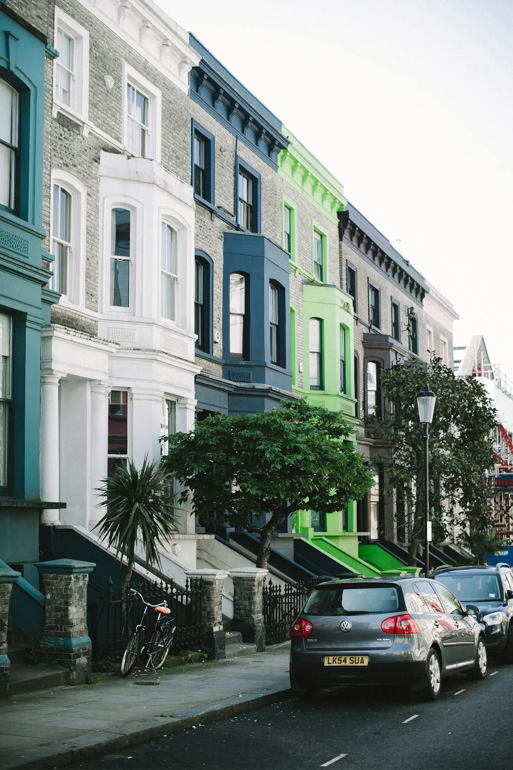 Colorful Victorian townhouses with teal, white and lime facades.