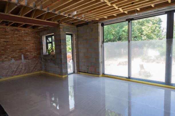 Newly installed self-leveling concrete floor in residential construction with natural lighting