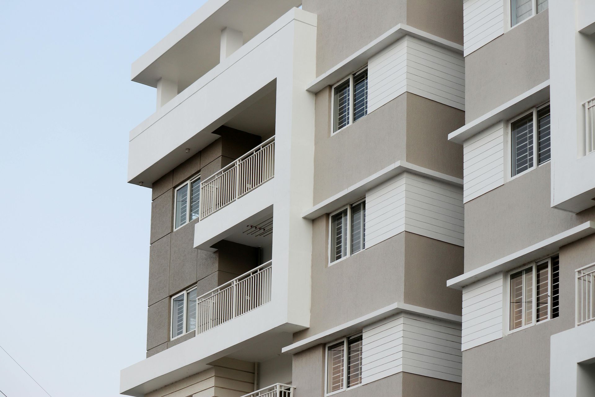 Modern commercial apartment building exterior showing multi-story construction project completion.