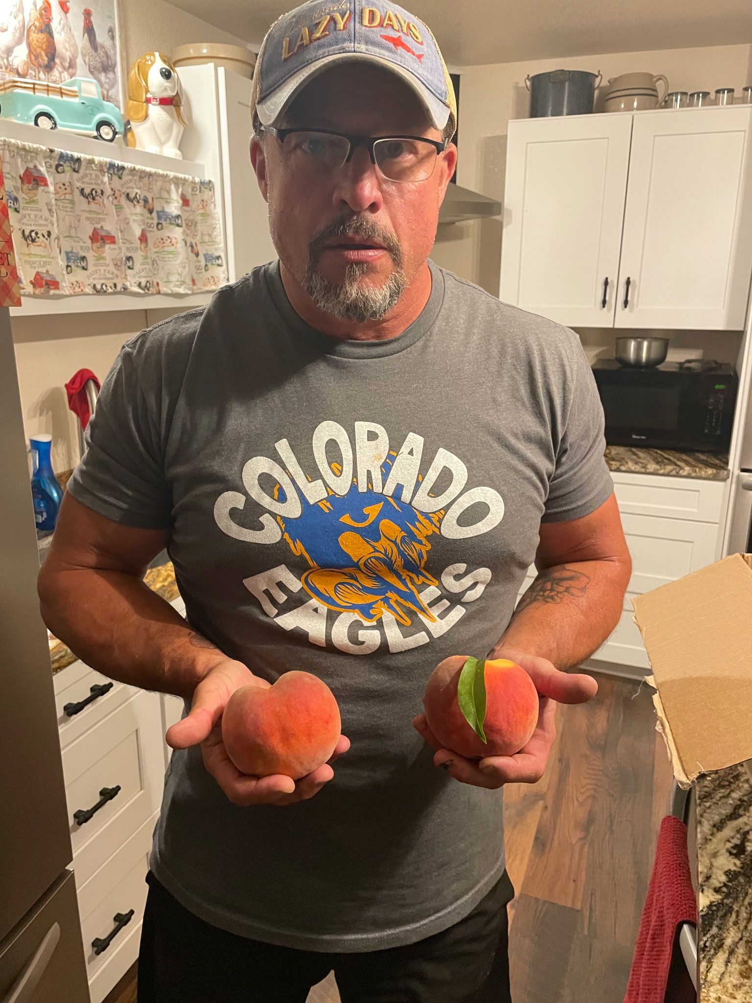 Man Holding Two Peaches
