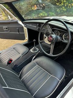 Interior view from the driver side of a white MGC GT 3