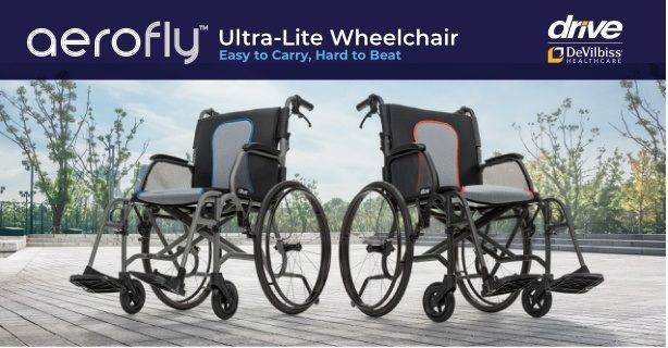 Two Aerofly ultra-lite wheelchairs on a wooden deck with a waterfront city skyline backdrop