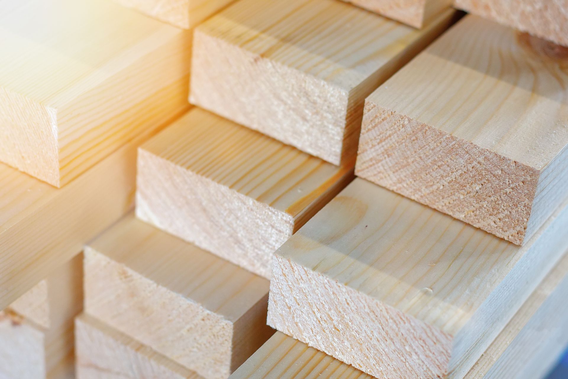 Stacked pine wood lumber boards and timber planks for construction and carpentry.