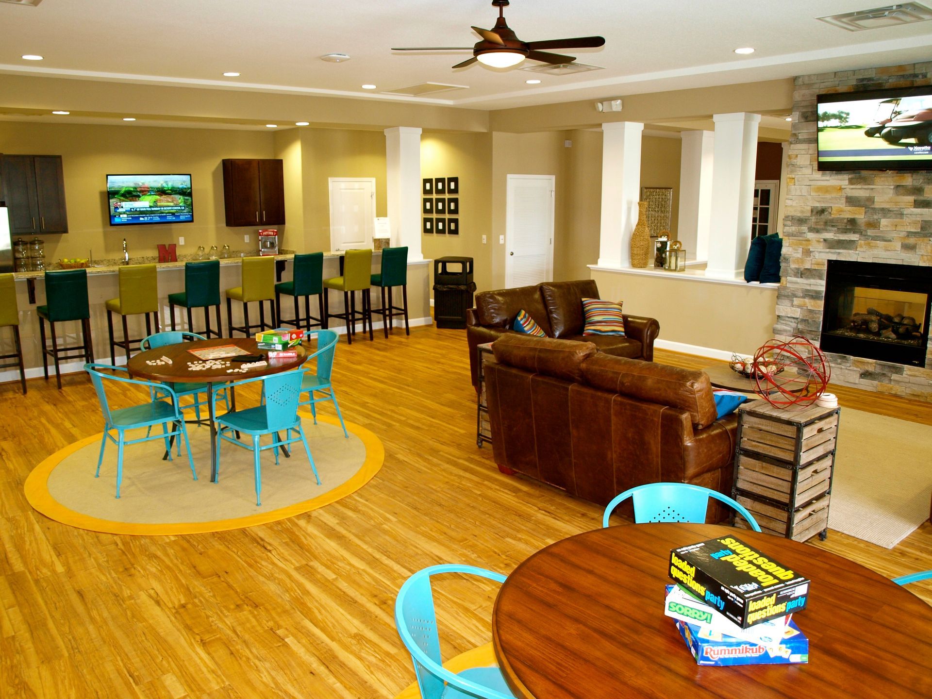 A living room filled with furniture and a ceiling fan