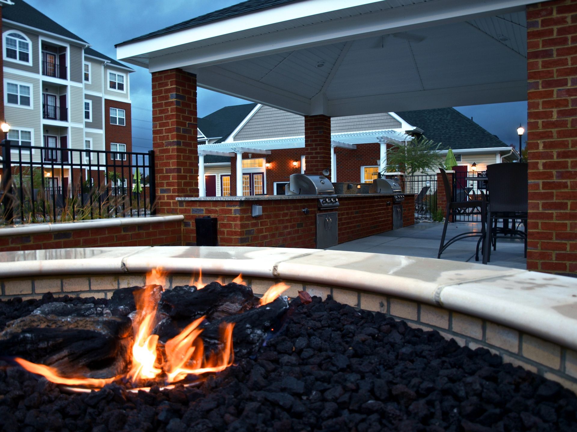 Outdoor community amenities at Marcella at Town Center in Hampton, VA with swimming pool, grilling pavilion, and fire pit.
