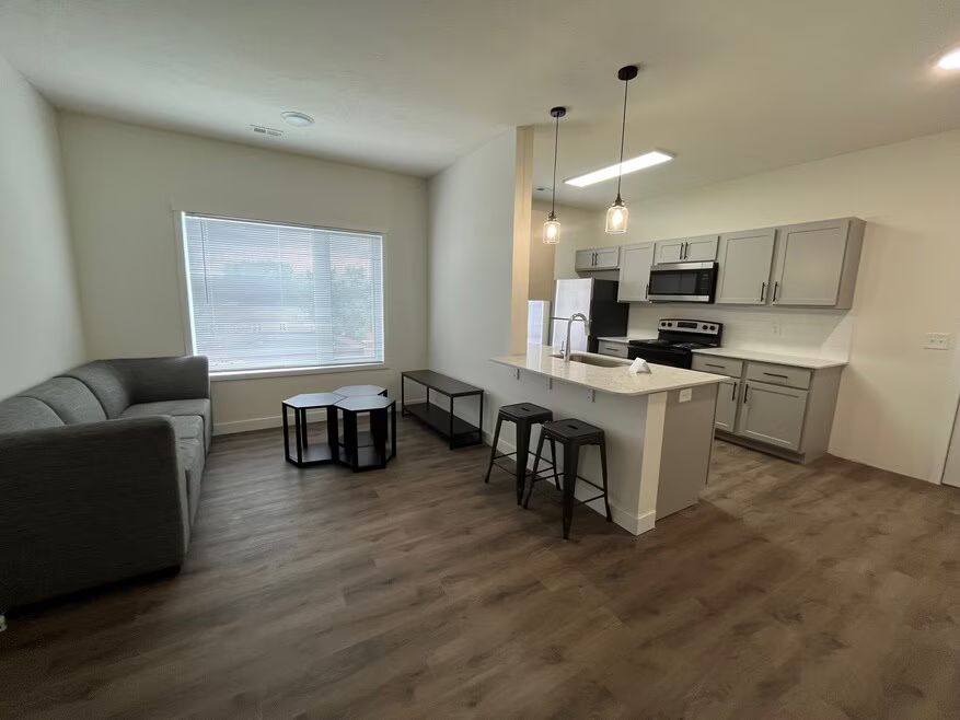 Modern open-concept apartment living area and kitchen in a Waldron apartment by Weida