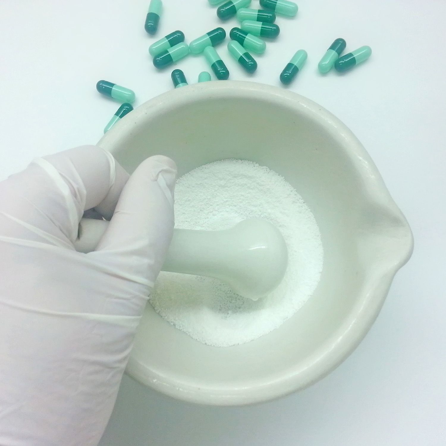 A mortar and pestle is being used to mix pills