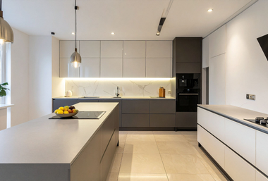 Modern kitchen with gray cabinetry, a large island, and marble backsplash.