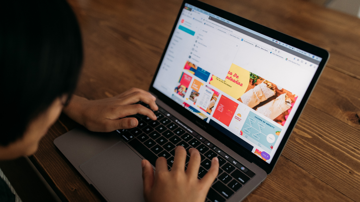 Boy browsing Canva on laptop
