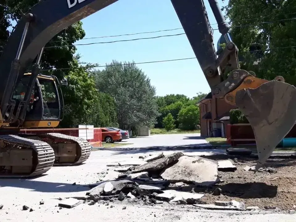 An excavator removing asphalt Montgomery County, Texas.