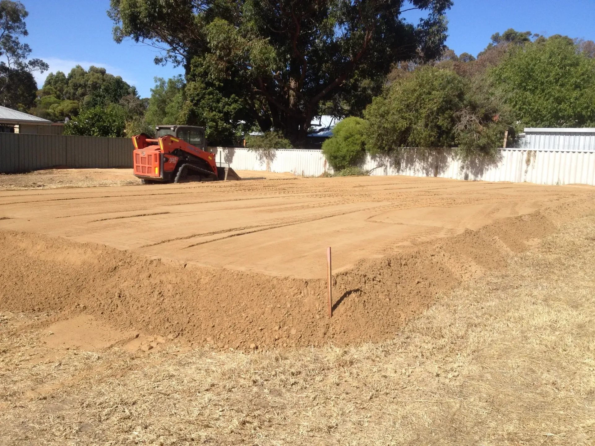 Trackloader preparing a shed pad in Conroe, Texas.