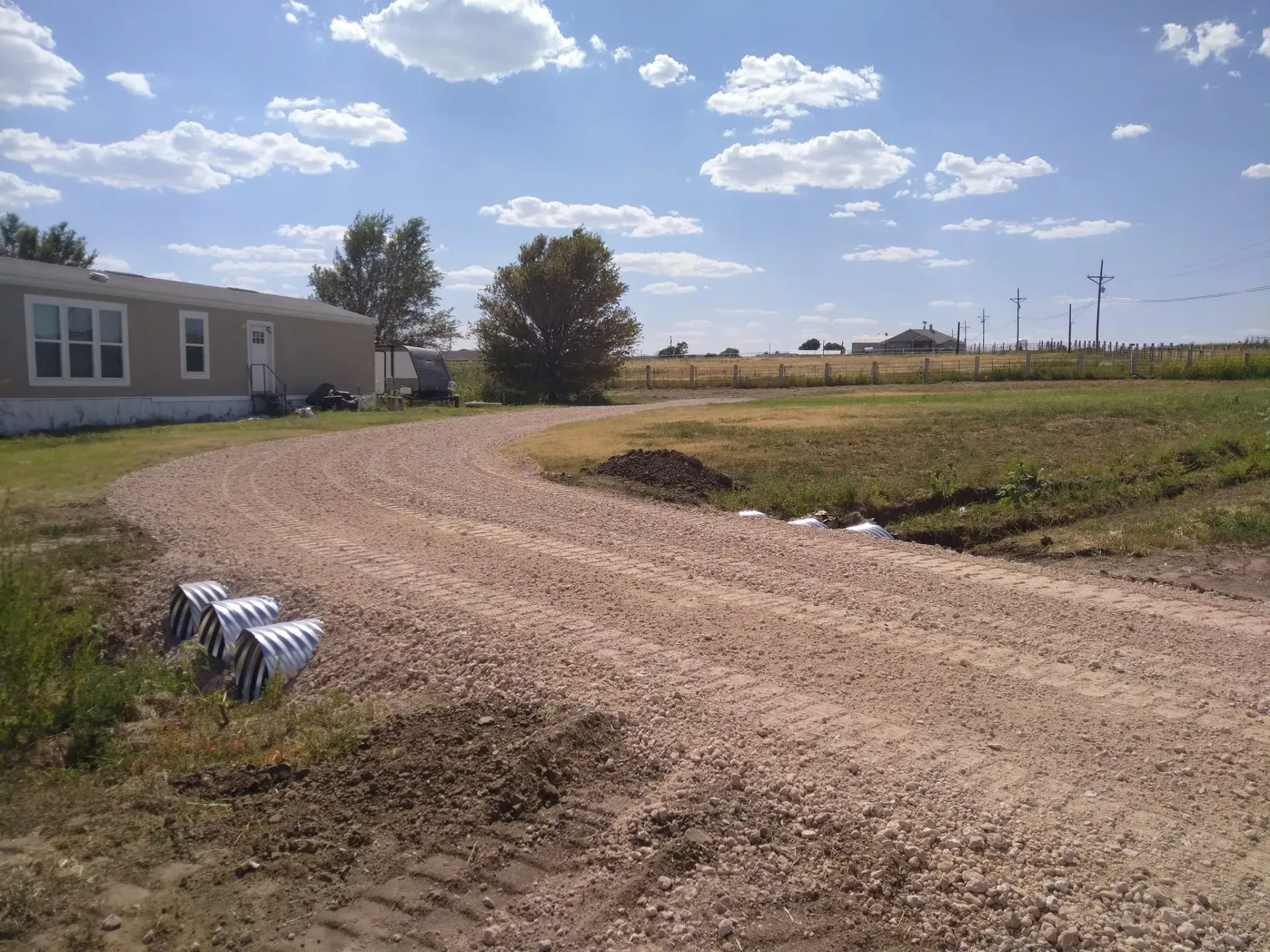 Newly installed driveway culverts next to a home in rural Conroe, TX. 