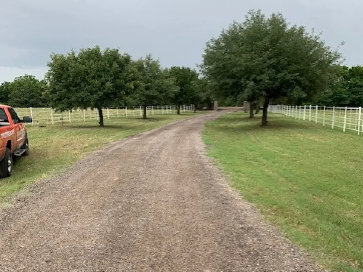 Gravel paving contractor putting in a new farm road in Montgomery County, Texas.