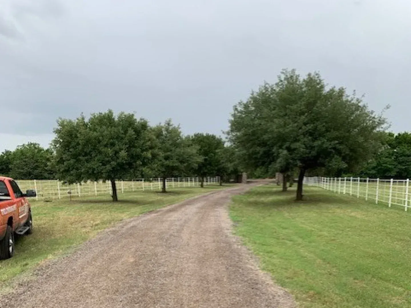 Gravel paving contractor putting in a new farm road in Walker County, Texas. 
