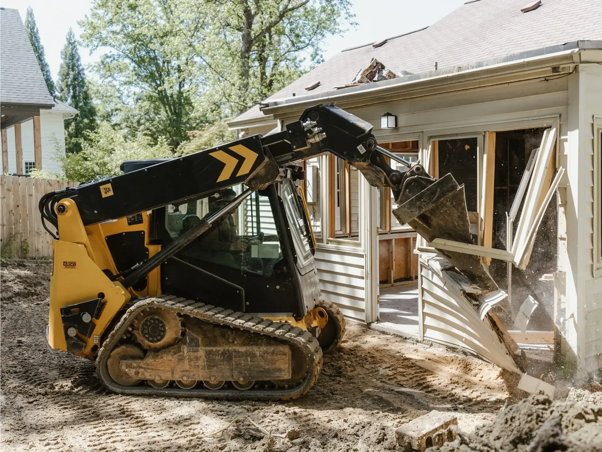 Track loader demolishing a home in Conroe, Texas.