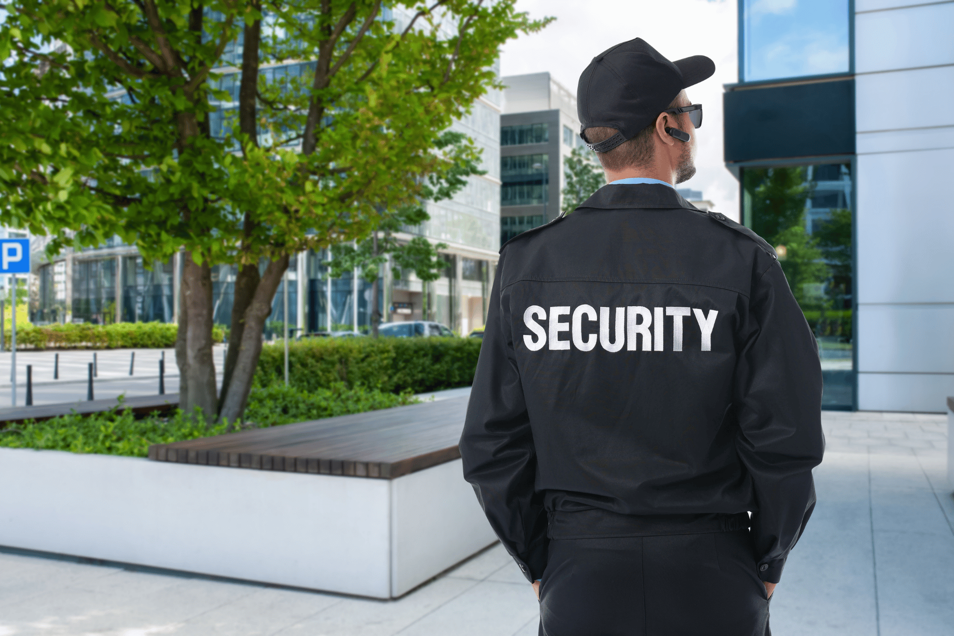 Security guard in a black uniform and cap with 